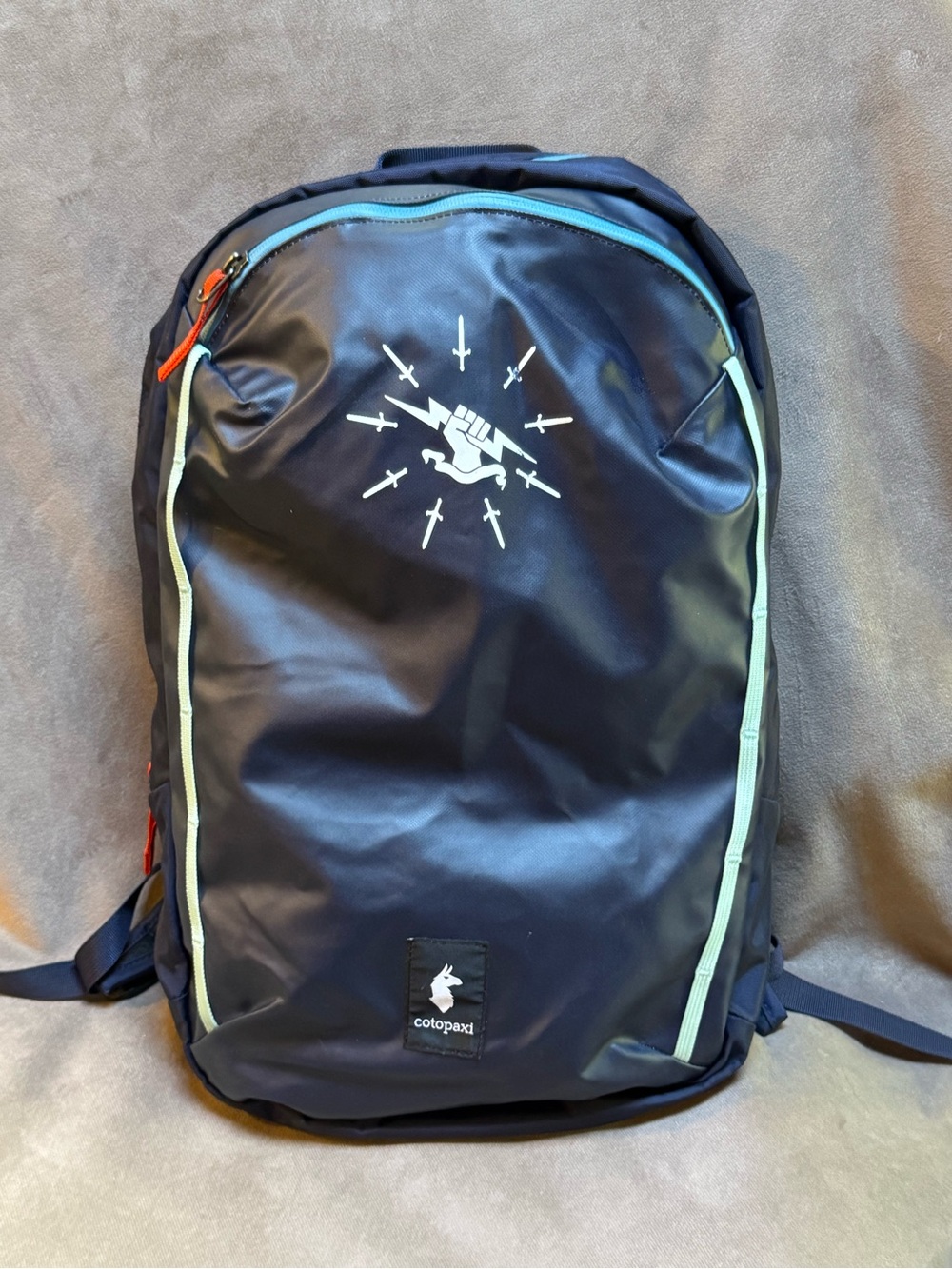 cotopaxi Navy Backpack with Mint Trim and Orange Pulls